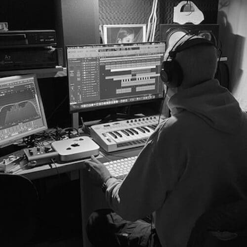 The K Program producing deep house in his studio, black and white photo